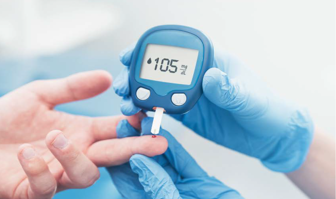 A patient undergoes a glucose test using a glucometer.
